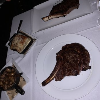 Roots Steakhouse - Bottom right Dry aged cowboy steak. Top left prime cowboy steak. Left is the local roasted mushrooms and potatoes au gratin. - Steakhouses Near Me - Summit, New Jersey