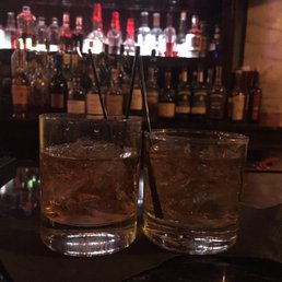 Two glasses of bourbon. Two glasses of bourbon.