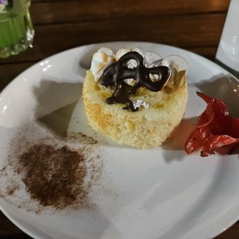 Old Lahaina Luau - Pineapple cake with a candied hibiscus - Performing Arts Near Me - Lahaina, Hawaii