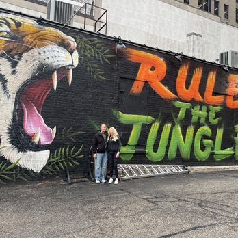 Kitty's Sports Grill - two people standing in front of a mural of a tiger - Sports Bars Near Me - Cincinnati, Ohio Kitty's Sports Grill - two people standing in front of a mural of a tiger - Sports Bars Near Me - Cincinnati, Ohio