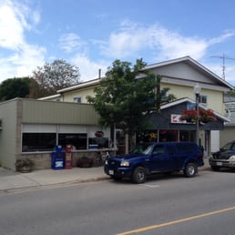two cars parked in front of a restaurant