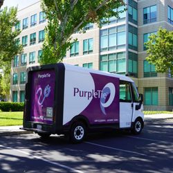 PurpleTie - A PurpleTie van parked at a corporate office of an @Work client