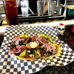 Bomb Burritos - Tacos de Asada w/ Pickled Habanero Red Onions w/ Avocado Slices paired with a Modelo Negra Michelada