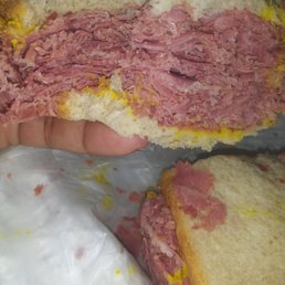 Big Beef - A corned beef sandwich with sliced bread and a generous filling of corned beef, shown in a close-up view.