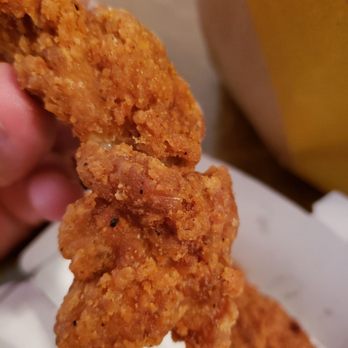 McDonald's - a hand holding a piece of fried chicken - Fast Food Near Me - Inverness, Florida McDonald's - a hand holding a piece of fried chicken - Fast Food Near Me - Inverness, Florida