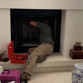 Wild things Wildlife Control - Jerry looking up the chimney with a camera - Wildlife Control Near Me