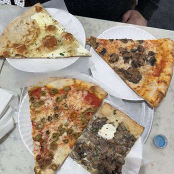Saba's Pizza Upper East - Green olive slice, mushroom ricotta slice, three cheese slice and a mushroom slice - Pizza Near Me - New York, New York Saba's Pizza Upper East - Green olive slice, mushroom ricotta slice, three cheese slice and a mushroom slice - Pizza Near Me - New York, New York