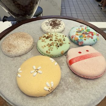Mini Monster Cafe - Macarons. Clockwise: Churro, Oreo, Fruity Pebbles, Strawberry, Vanilla, and Pistachio in the center - Ice Cream & Frozen Yogurt Near Me - Long Beach, California Mini Monster Cafe - Macarons. Clockwise: Churro, Oreo, Fruity Pebbles, Strawberry, Vanilla, and Pistachio in the center - Ice Cream & Frozen Yogurt Near Me - Long Beach, California