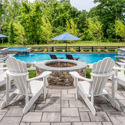 xScape formerly Deckscapes of VA - Poolside fire pit patio designed for year-round gatherings and relaxed evenings outdoors.