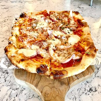 The Grocer's Table - Grocer's Table craft paper peeking under the Salumi pizza.  Leftovers will never be the same. - Cafes Near Me - Wayzata, Minnesota