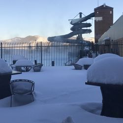 Whispering Willows Spa and Massage - Inside, looking out through all the snow at the warm and inviting pool and slide.