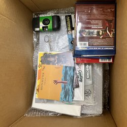 Black Belt Movers - This box is a Ps5 (500$) stacked ON TOP of vinyl records (at least 200$ worth) in a half empty box with scissors, a camera and DVDs..