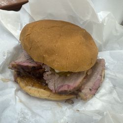 Mikeska Barbeque - The sliced brisket sandwich with onions, barbecue sauce, pickles, and jalapenos