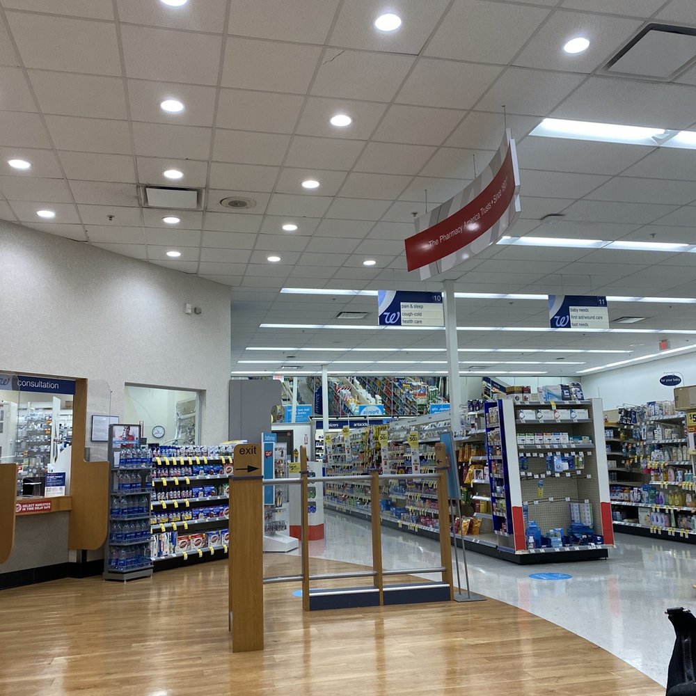 Waiting for Covid -19 Vaccine with others - pharmacy area . They have chairs spaces apart for safety. Waiting for Covid -19 Vaccine with others - pharmacy area . They have chairs spaces apart for safety.