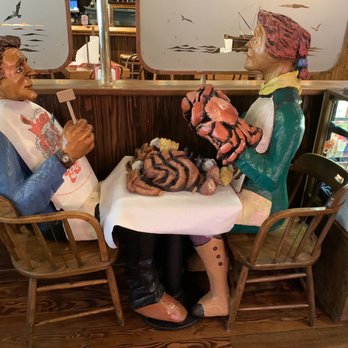 The Crab Pot - Wooden statues enjoying their meal! - Seafood Near Me - Seattle, Washington The Crab Pot - Wooden statues enjoying their meal! - Seafood Near Me - Seattle, Washington