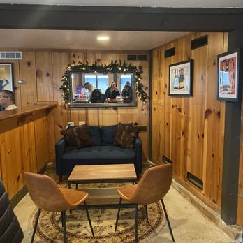 Simply Bubbles - a living room with wood paneled walls - Champagne Bars Near Me - Sutter Creek, California