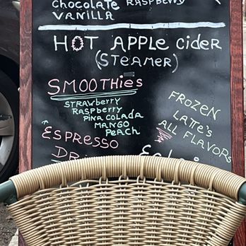 Java by the Bay - a menu for hot chocolate and green tea - A black chalkboard menu outside a coffee shop lists hot chai flavors, hot apple cider, smoothies, and frozen drinks, with decorative handwriting. - Coffee & Tea Near Me - Havre De Grace, Maryland