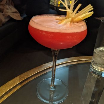SM23 - a red cocktail with a pineapple garnish - Lounges Near Me - Morristown, New Jersey