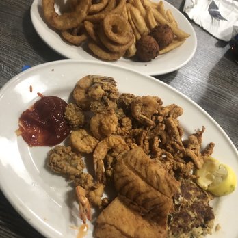 Hull's Seafood - Fried seafood platter (cod, clam strips, oysters, shrimp, crab cakes) with fries and onion rings. Decent fried seafood with great portions! - Seafood Near Me - Ormond Beach, Florida