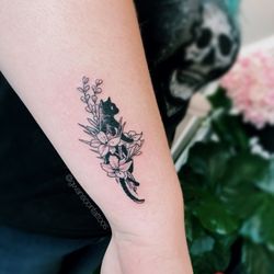 Gwan Soon Lee Tattoos & Piercing - Black cat tattoo with floral designs on arm.