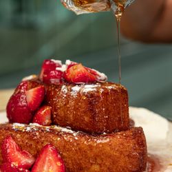 Tres Leches French Toast: Brioche, Tres Leches Custard, Cinnamon, Rum Dulce de Leche, Gold Flakes, Whipped Cream & Strawberries