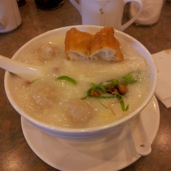 Congee Noodle King - Congee with Fish Ball, fried bread, peanuts, and an egg (cooking at the bottom) - Chinese Near Me - Vancouver, British Columbia Congee Noodle King - Congee with Fish Ball, fried bread, peanuts, and an egg (cooking at the bottom) - Chinese Near Me - Vancouver, British Columbia