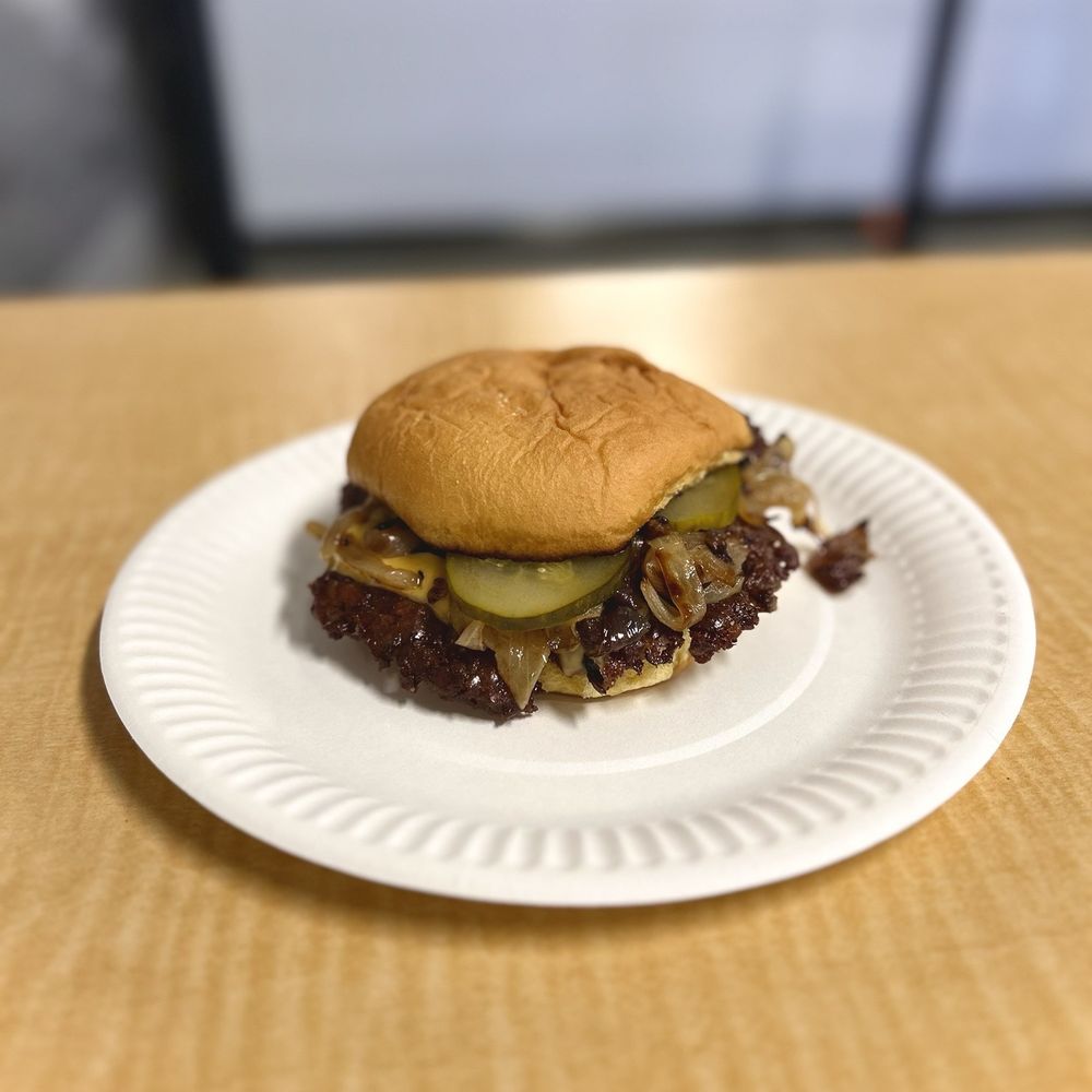 a hamburger on a paper plate a hamburger on a paper plate