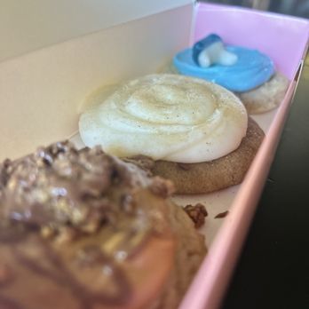 Crumbl - Edmond - Left to Right: Peanut Butter Cup w/ Reese's, Snickerdoodle Cupcake, Sugar Cookie w/ Gummy Shark - Bakeries Near Me - Edmond, Oklahoma Crumbl - Edmond - Left to Right: Peanut Butter Cup w/ Reese's, Snickerdoodle Cupcake, Sugar Cookie w/ Gummy Shark - Bakeries Near Me - Edmond, Oklahoma
