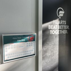 Full Ride Cycling - Bike room door and map