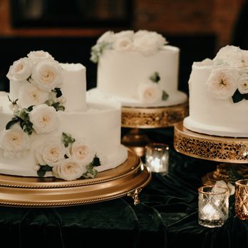 Fantasy Frostings - three white wedding cakes on a table - Custom Cakes Near Me Fantasy Frostings - three white wedding cakes on a table - Custom Cakes Near Me