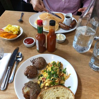 Lola - My scramble with smashed potatoes + bread- boyfriend's pancakes + sausage + fruit bowl. - Greek Near Me - Seattle, Washington Lola - My scramble with smashed potatoes + bread- boyfriend's pancakes + sausage + fruit bowl. - Greek Near Me - Seattle, Washington