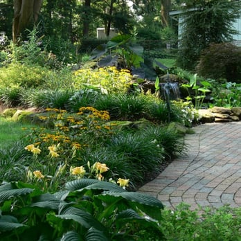 Fleck & Son's Landscape Service - a brick walkway in a garden - Landscaping Near Me - Olmsted Falls, Ohio Fleck & Son's Landscape Service - a brick walkway in a garden - Landscaping Near Me - Olmsted Falls, Ohio