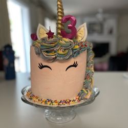 Mad Batter Bakehouse - Unicorn cake. 8" cake, three layers, dense white moist cake with strawberry mousse in between, and butter cream frosting.