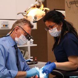 Burnaby Dental & Implant Centre - Dr. Peter Balogh at work, being assisted by Bahar