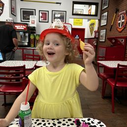 Chips, chocolate milk and her new favorite hat.