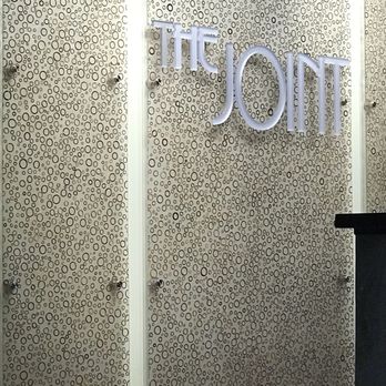 The Joint Chiropractic - Sign behind front desk - Chiropractors Near Me - Smyrna, Georgia