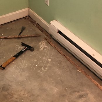 Get Well Home Improvements - a floor with a hammer and nails - Painters Near Me