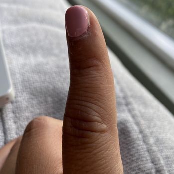 Zen Nail Bar - Right pinky with dried top coat on edge of the nail. Can feel it lifting already - Nail Salons Near Me - Riverside, California