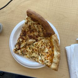 Slice of Chicken Bacon Ranch Pizza and Buffalo Chicken Pizza