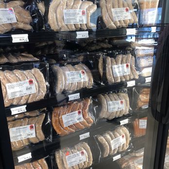 Korte Meat Processing - Frozen bratwurst sausages in clear plastic packaging are displayed on refrigerated shelves at a store, with price tags visible. - Meat Shops Near Me - Highland, Illinois