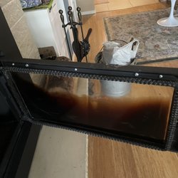 Chimcare Wilsonville - The inside of the glass door on the wood stove insert. It takes about an hour to remove the baked-on soot.