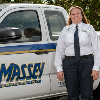 Massey Services - a woman in uniform standing in front of a truck - Pest Control Near Me - Fort Worth, Texas Massey Services - a woman in uniform standing in front of a truck - Pest Control Near Me - Fort Worth, Texas