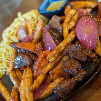 Sona Fusion Kitchen - Lomo Saltado Shaken Fries With Filet Mignon, Subbed Rice For Garlic Noodles - Asian Fusion Near Me - Anaheim, California Sona Fusion Kitchen - Lomo Saltado Shaken Fries With Filet Mignon, Subbed Rice For Garlic Noodles - Asian Fusion Near Me - Anaheim, California