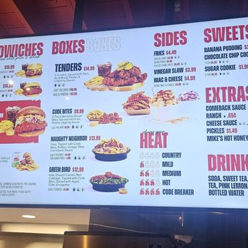 BIRDCODE - A digital menu board lists sandwiches, boxes, sides, sweets, extras, and drinks available at a restaurant, with prices and descriptions. - Chicken Shop Near Me - West Hartford, Connecticut