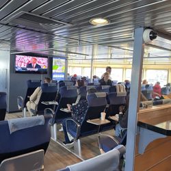 Seastreak Ferry - Seating first floor. Football playing on all monitors.