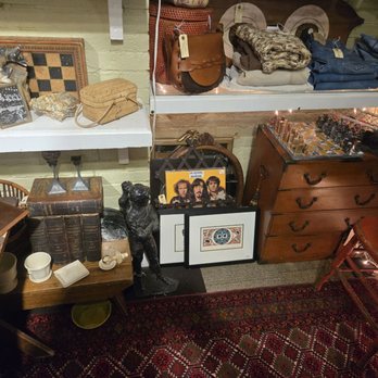 Crompton Collective - Vintage and antique collectibles, including framed artwork, books, sculptures, and small home decor items, are arranged on shelves and tables. - Used, Vintage & Consignment Near Me - Worcester, Massachusetts