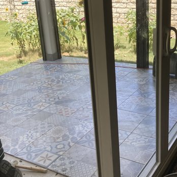 Dollar Tile - a view of a patio through a sliding glass door - Flooring Near Me - Buda, Texas
