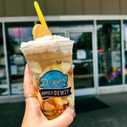 a hand holding a cup of ice cream a hand holding a cup of ice cream