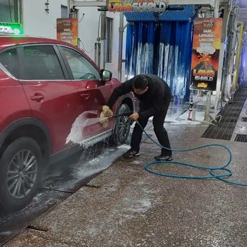 Pro-Clean Car Wash Express - Attendant scrubbing tough debris off of side doors - Car Wash Near Me - Rock Island, Illinois Pro-Clean Car Wash Express - Attendant scrubbing tough debris off of side doors - Car Wash Near Me - Rock Island, Illinois