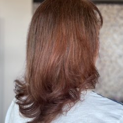 A warm, rich brunette with soft copper tones for a healthy, glossy finish. Ready for a fresh new look? We'd love to help!
